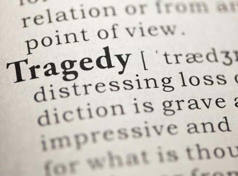 Close-up of the word Tragedy in a dictionary