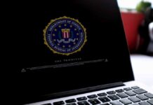 Laptop screen displaying FBI seal and warning text.