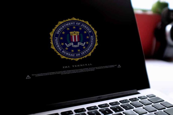 Laptop screen displaying FBI seal and warning text.