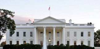 White House with fountain and flag.