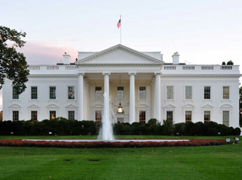 White House with fountain and flag.