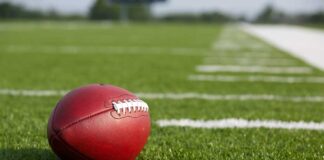 Football resting on a grassy field.