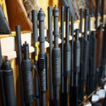 Rifles and shotguns displayed on a rack.