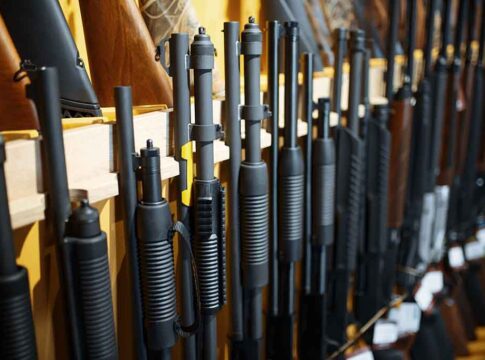Rifles and shotguns displayed on a rack.
