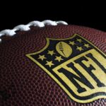 Close-up of football with NFL logo.