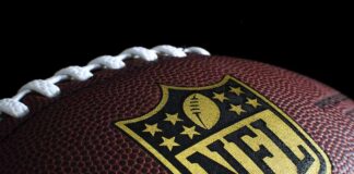 Close-up of football with NFL logo.
