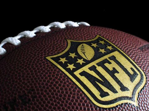 Close-up of football with NFL logo.