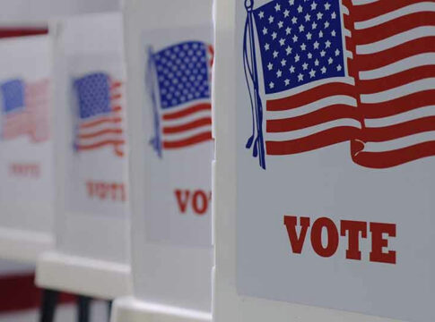 Voting booths with American flags and VOTE signs