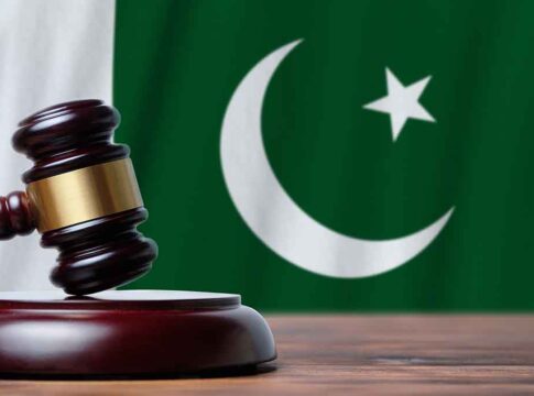 Gavel with Pakistan flag in the background.