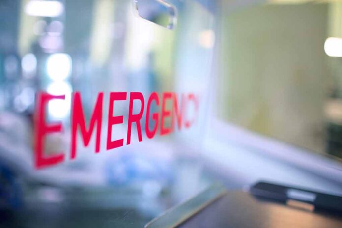 Red EMERGENCY sign on glass door.