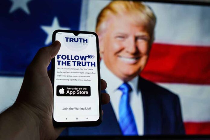 Hand holding phone with Truth Social app screen.