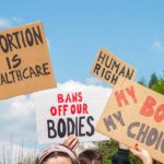 People holding pro-choice signs at a demonstration.
