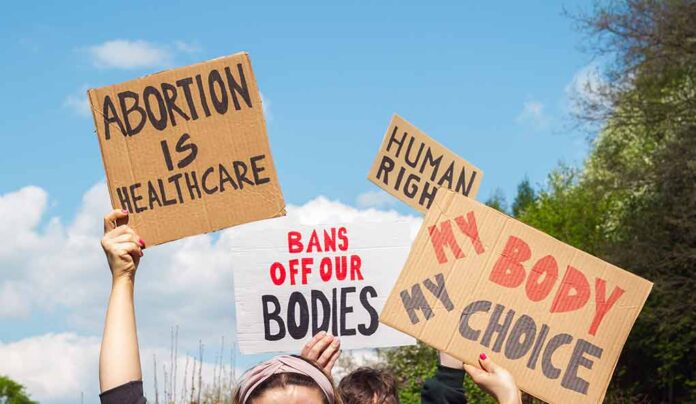 People holding pro-choice signs at a demonstration.