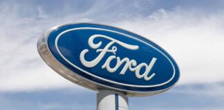 Blue Ford logo sign against the sky.