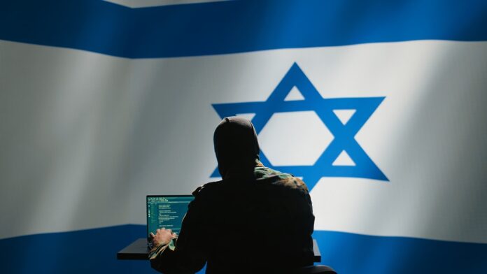2481173299 featured image Hacker in front of Israeli flag with laptop.
