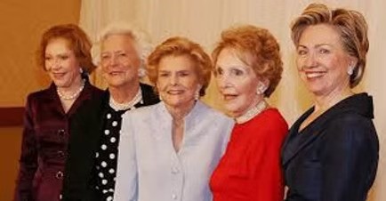 Five former First Ladies of the United States posing together at a formal event