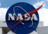 NASA logo outside building with blue sky background.