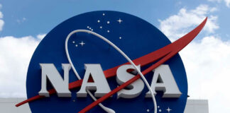 NASA logo outside building with blue sky background.