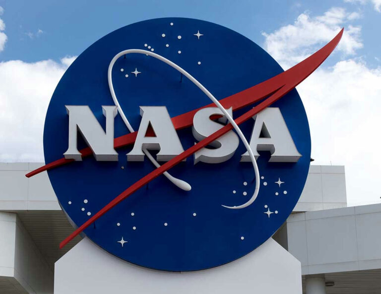 NASA logo outside building with blue sky background.