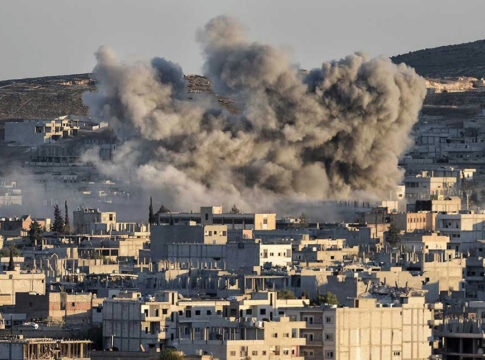 Smoke rising from buildings in a city.