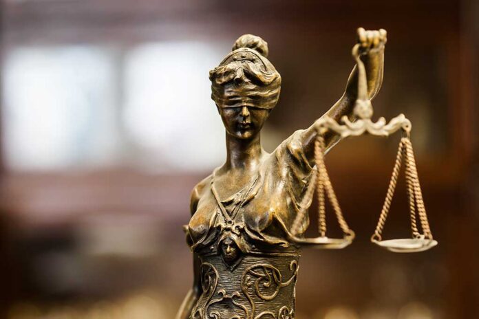 380912410 featured image Bronze Lady Justice statue holding scales.