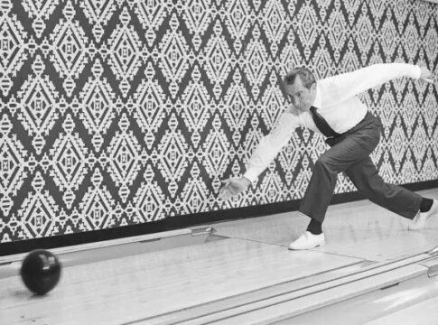 A U.S. President bowling in a vintage setting