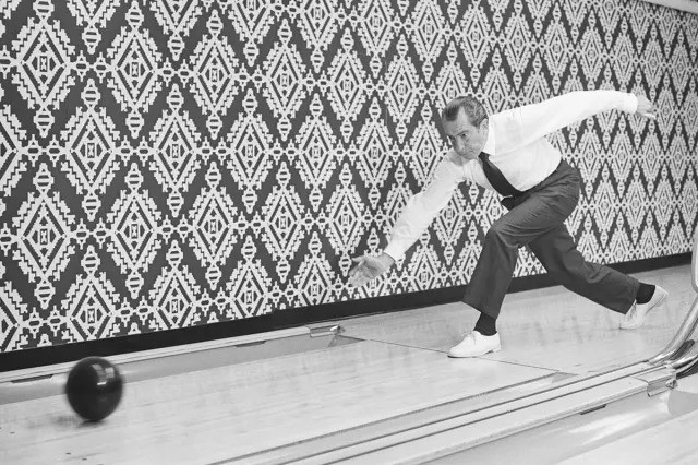 A U.S. President bowling in a vintage setting