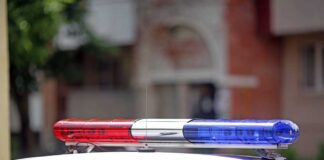 Police car with red and blue siren lights.