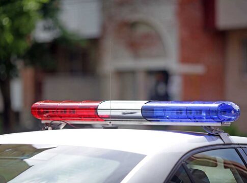 Police car with red and blue siren lights.