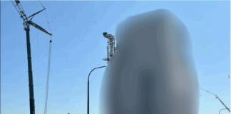 Construction site with cranes and equipment under a clear blue sky