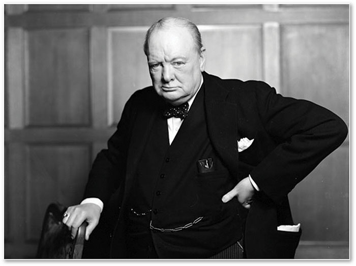 Black and white portrait of Winston Churchill in formal attire with a serious expression