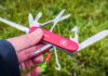 A Swiss Army Knife held in a hand, showcasing multiple tools including blades and scissors