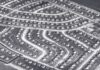 Aerial view of a suburban neighborhood featuring winding streets and rows of houses
