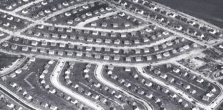 Aerial view of a suburban neighborhood featuring winding streets and rows of houses