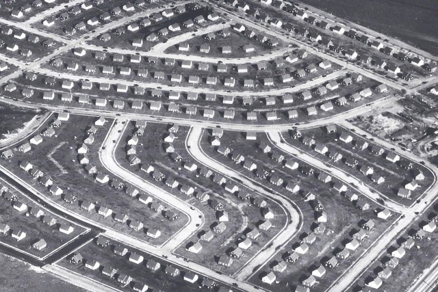 Aerial view of a suburban neighborhood featuring winding streets and rows of houses