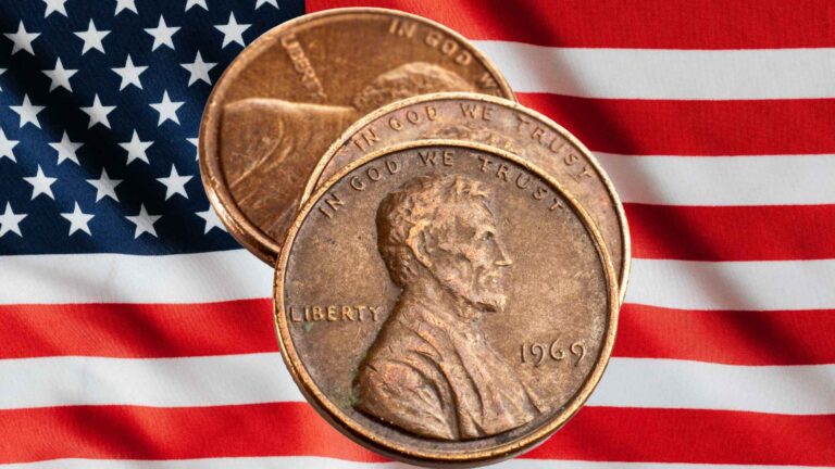 Three Lincoln pennies on a background of the American flag