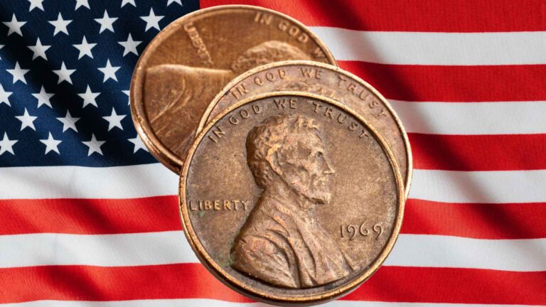 Three Lincoln pennies on a background of the American flag