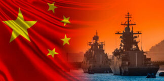 Chinese flag overlaying naval ships at sunset.