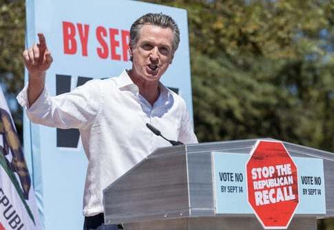 Gavin Newsom speaking at a podium, 