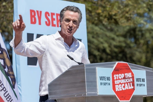 shutterstock2036606894jpg Gavin Newsom speaking at a podium, "Stop the Republican Recall."