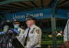 Police officers giving a statement at Union Square station.
