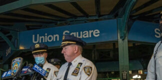Police officers giving a statement at Union Square station.