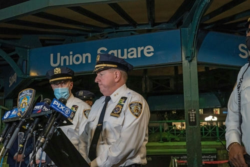 Police officers giving a statement at Union Square station.