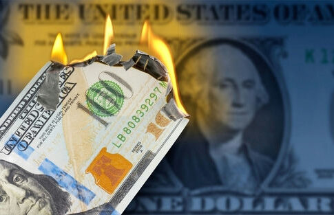 Burning US hundred-dollar bill with flames at the corner