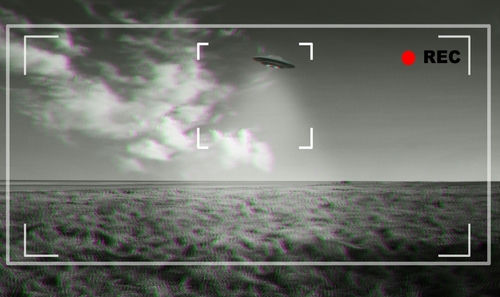 shutterstock2300957043-1jpg Black and white footage of UFO over a field.