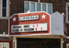 Cinema marquee displaying "Indiana Jones" and "Sound of Freedom".