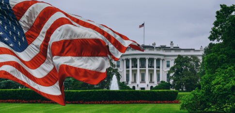 U.S. flag waving in front of the White House.