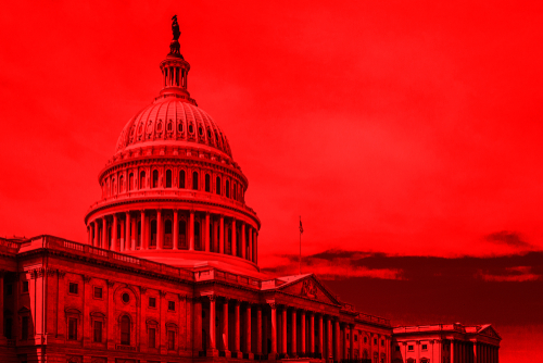 shutterstock_1142146865.jpg featured image United States Capitol building under red-hued sky.
