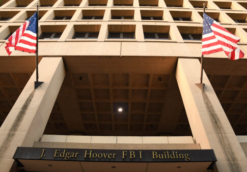 Exterior view of the J. Edgar Hoover FBI Building with American flags