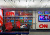 CNN World Headquarters studio with empty red chairs.